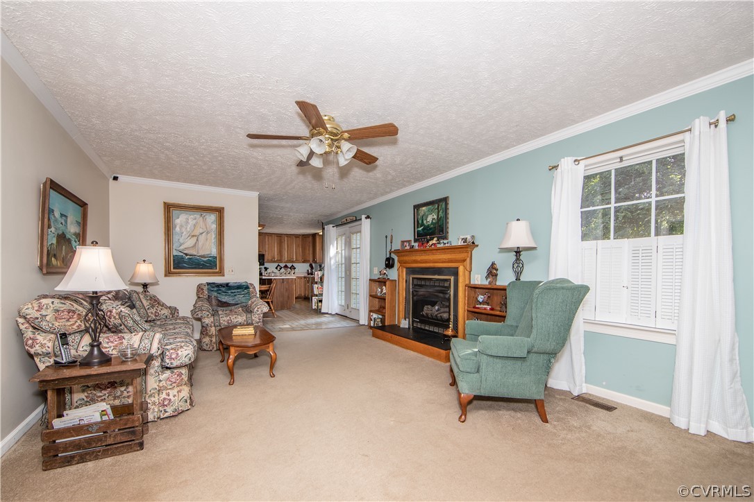 The family room boasts carpet, a ceiling fan, and a fireplace to keep it nice and cozy.