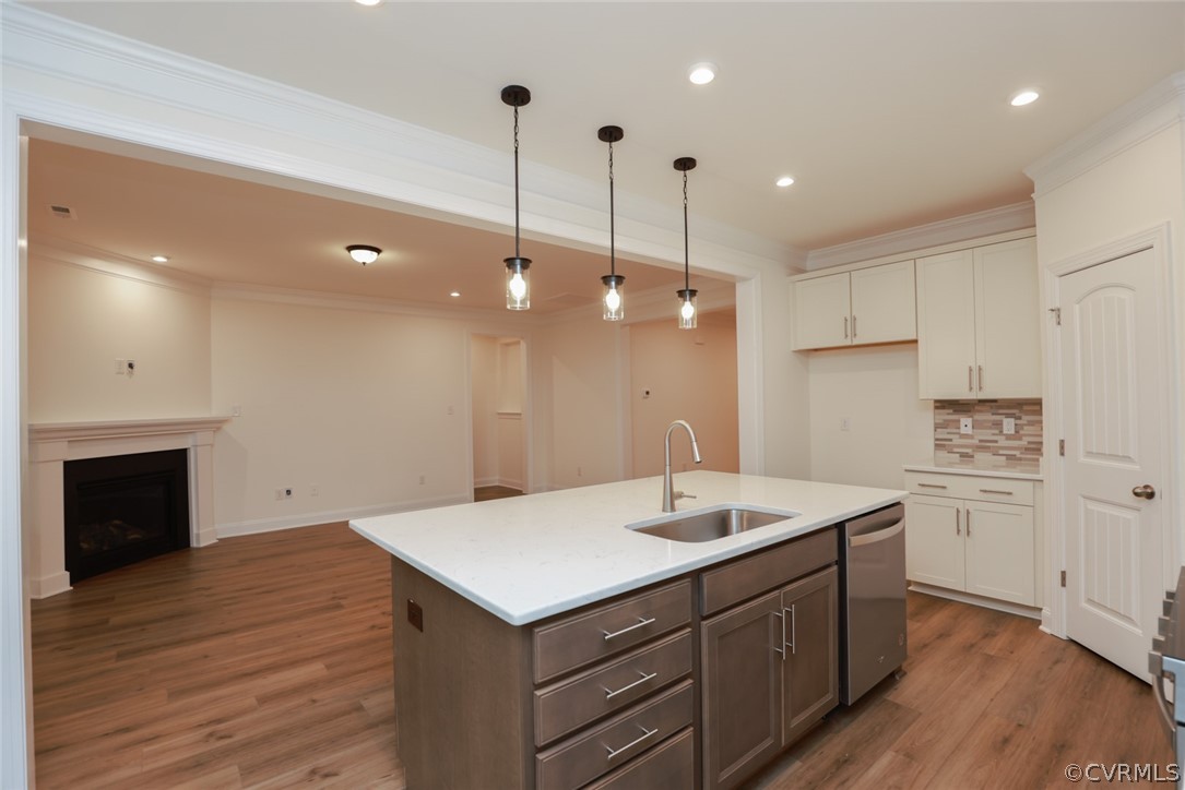 Professional photos have been added. Kitchen featuring quartz counters, tile backsplash, 42” cabinets, SS appls, gas cooking, and island is open to the bright and cheery breakfast nook. Family room w/ corner gas FP looks out onto the covered porch.