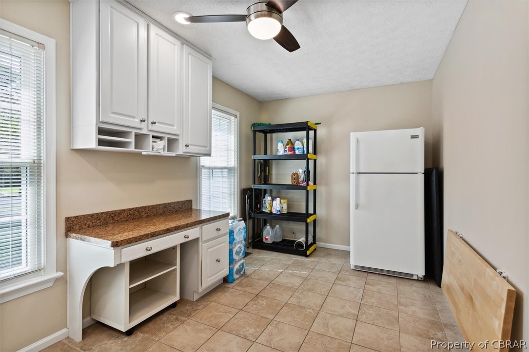 A truly LARGER than LARGE laundry room.  And yes, another frig/freezer that conveys.  See the ceiling fan and the work station??