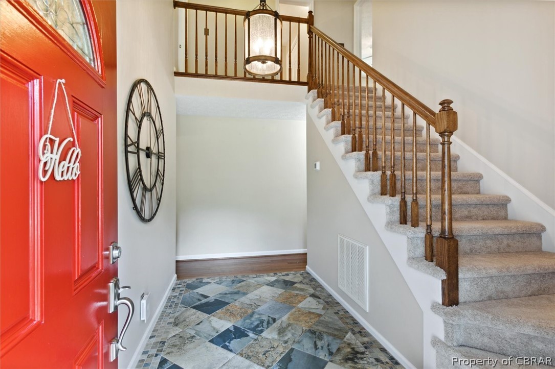 Let this slate tile floor and 2 story foyer greet you as you enter.