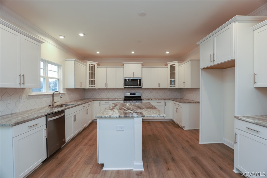 Photo represents the plan not the actual home. Enjoy entertaining guests in the family room or breakfast area, open to the kitchen. Kitchen features UPGRADED cabinets w/ glass corner cabinet, island, granite, walk-in pantry, and gas cooking.