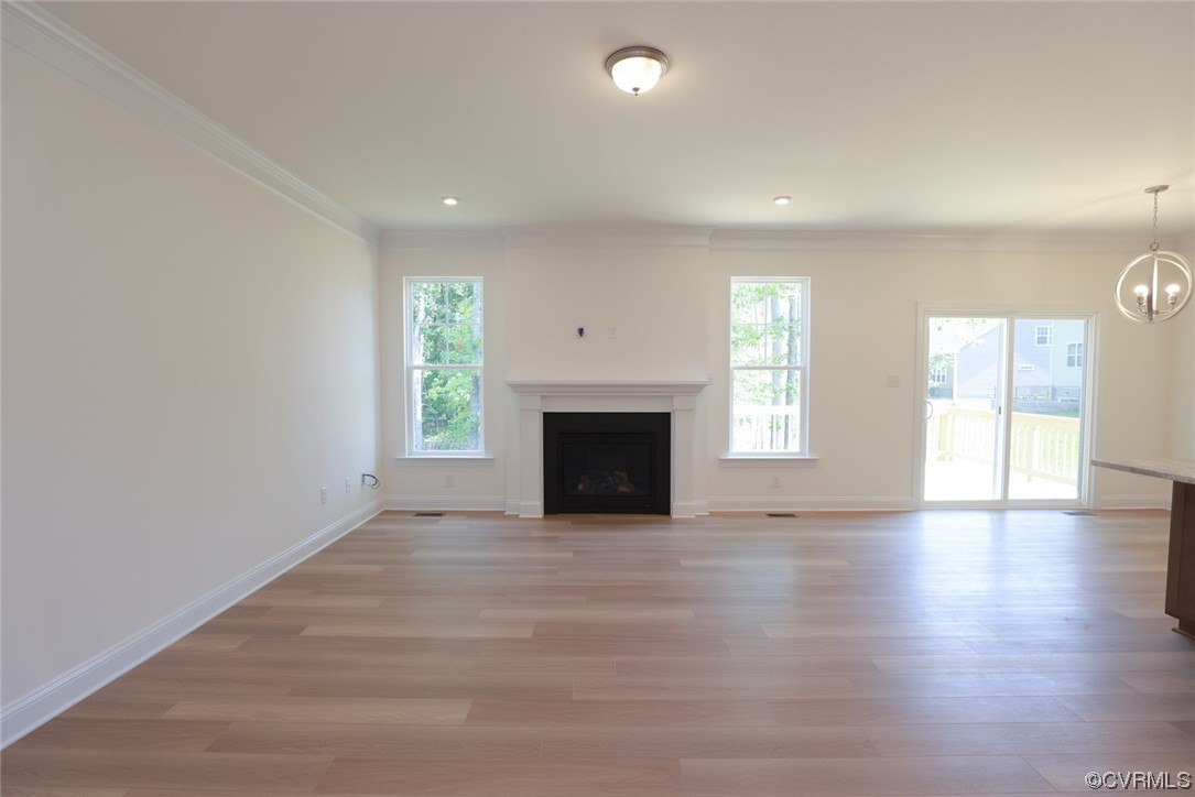 Family room with gas fireplace and hardwood flooring.