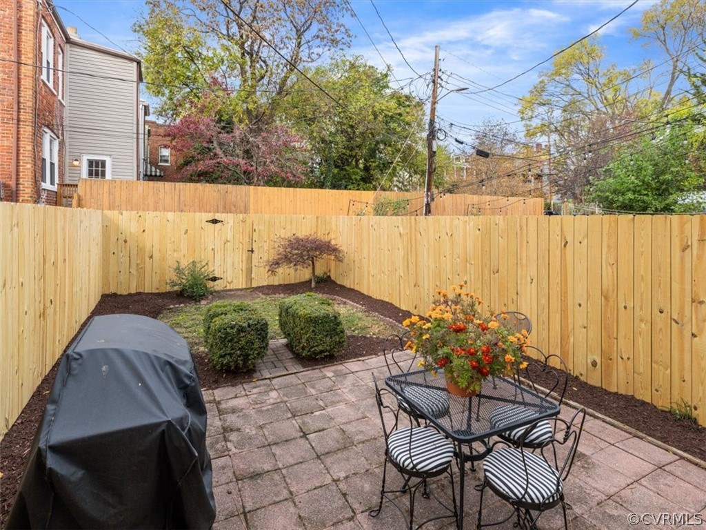 Fenced Backyard with brick paver patio.