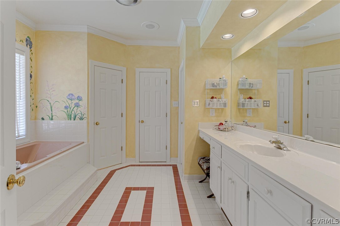 Ceramic tile floor, jetted tub overlooking the pool, vanity with sink and dressing table, walk-in shower with ceramic tile surround, toilet closet, linen closet, door to huge walk-in closet.