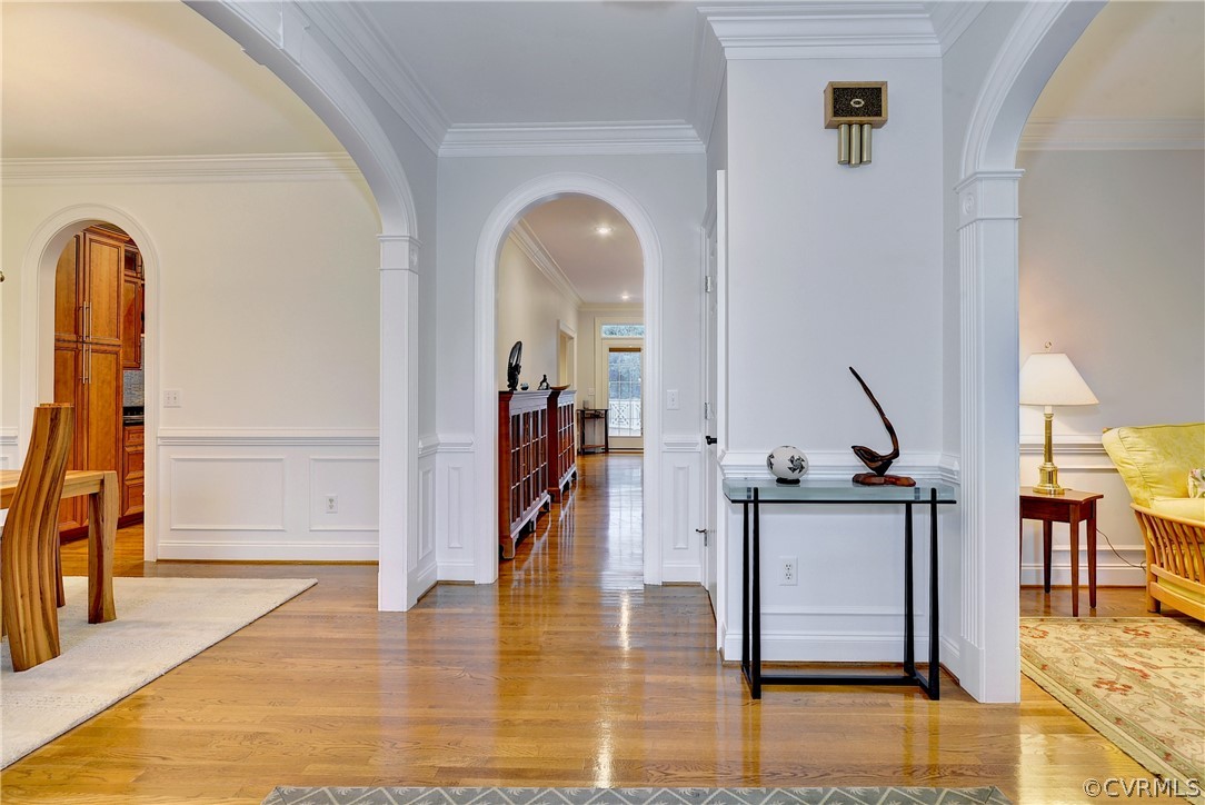 The beautiful foyer features arched doorways to the elegant living and dining rooms.