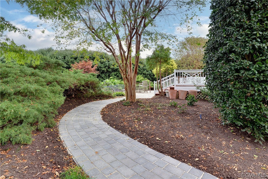 Gorgeous outdoor living spaces include a large deck, water feature/pond with koi fish, and low-maintenance gardens.