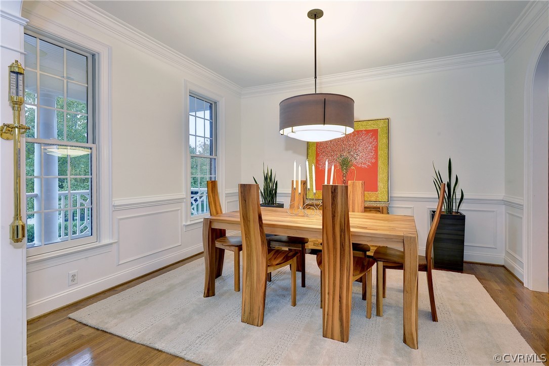 The dining room is located to the left of the foyer and features hardwood floors.