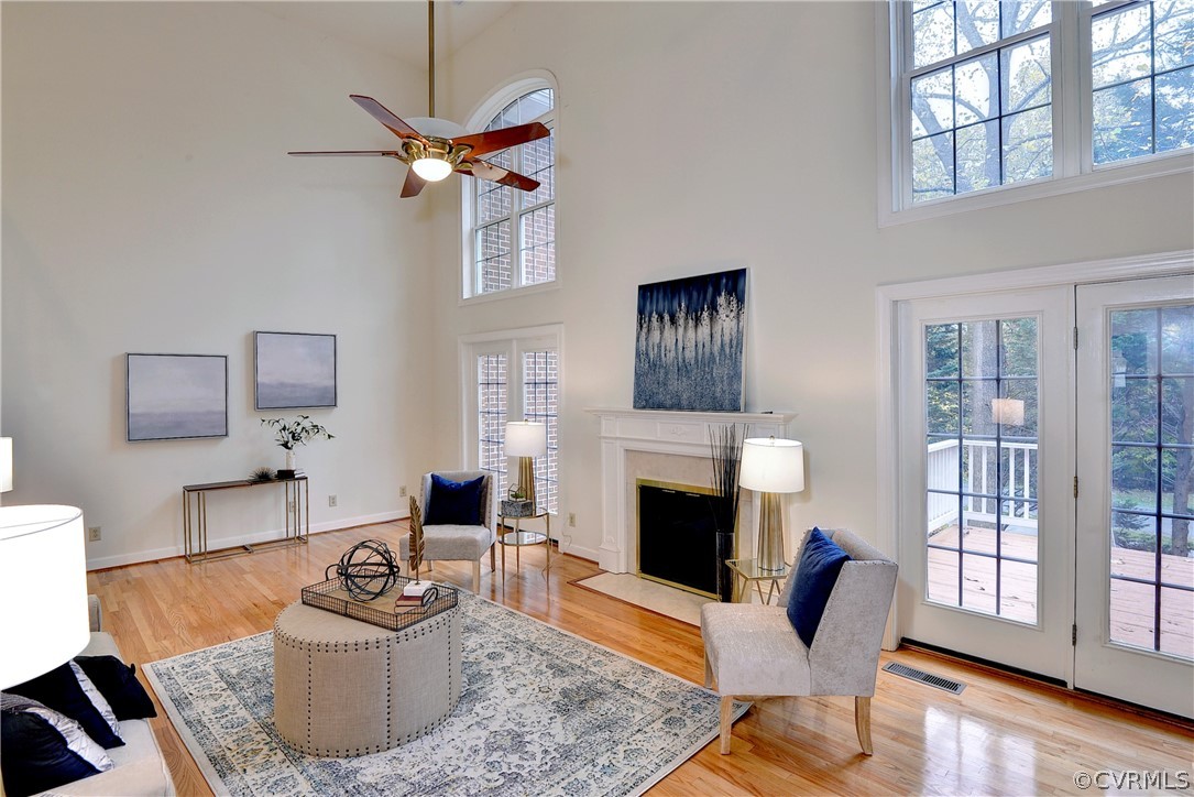 The light filled great room features a Cathedral ceiling, hardwood floors and fireplace.