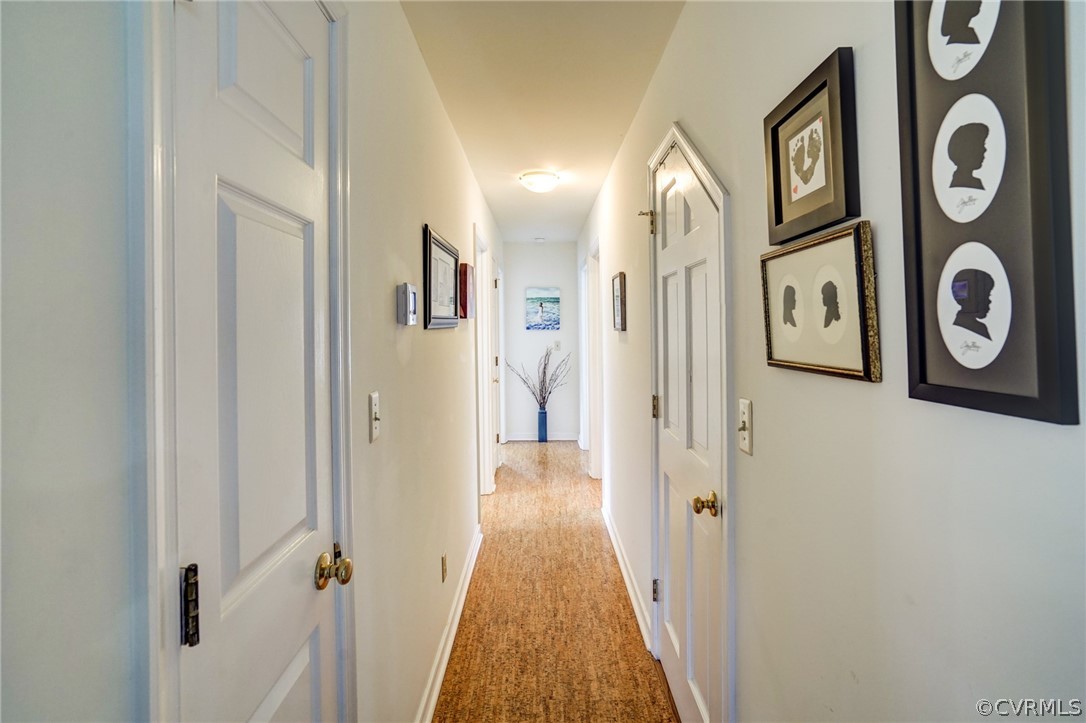 Hall leads to 2 bedrooms and 2 full bathrooms on the first floor