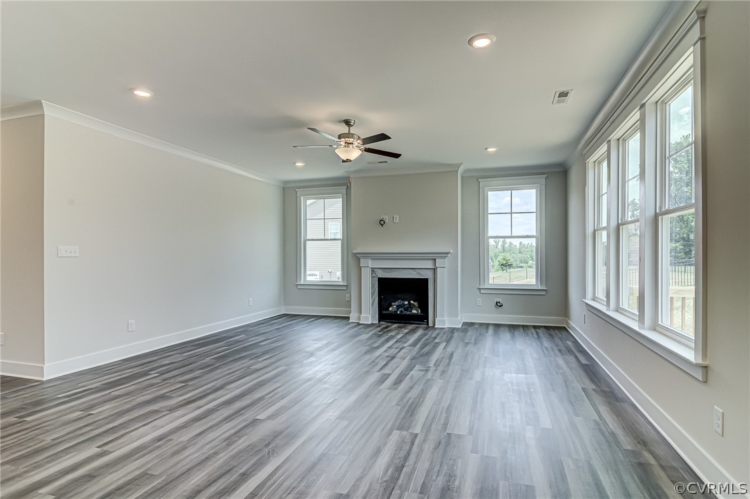 Photo represents the plan, not the actual home. Design selections may vary. Continuing into the main living area you’ll find the spacious family room w/ gas fireplace and recessed lighting.