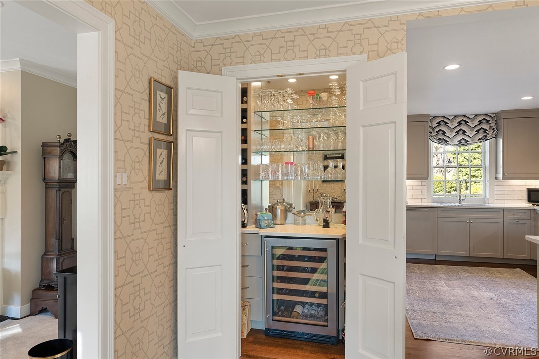 Wood doors can conceal this pretty wet bar, but why?  Wine refrigerator under counter and plenty of storage.
