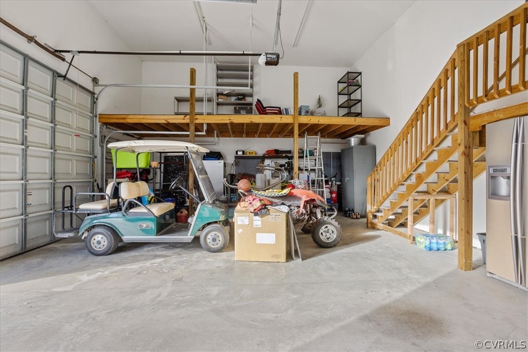 Extra storage area up top in this enormous finished garage with three bays.