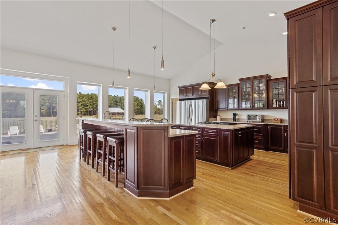 This Chef's kitchen is so beautiful with all the wood cabinets and counters.  So much natural light makes it spectacular!  Love the tall windows and french doors that go out to the inground pool area!  So convenient for enjoying the outside space!