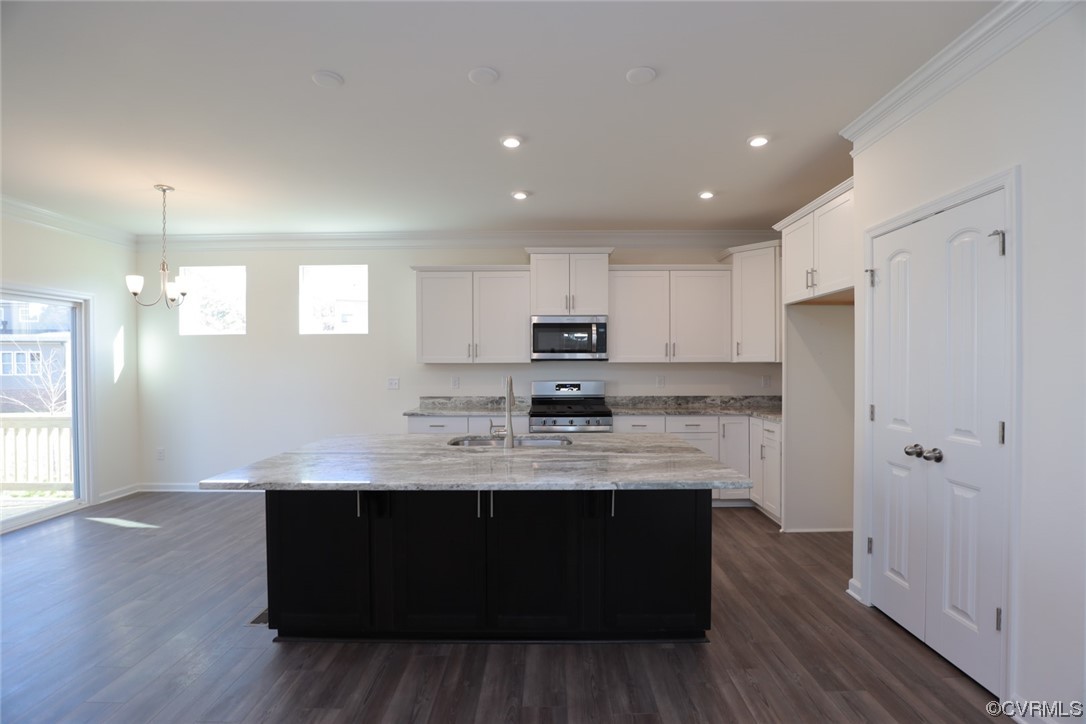 Kitchen features granite countertops, island, pantry and LED recessed lighting.
