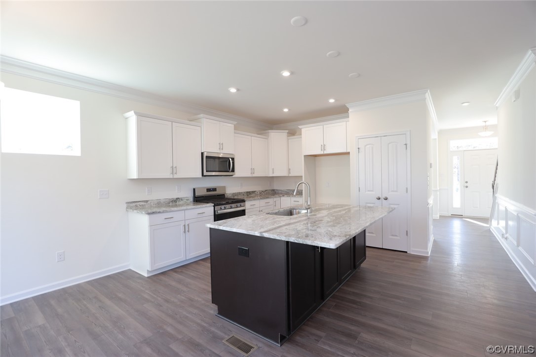 Kitchen features granite countertops, island, pantry and LED recessed lighting.