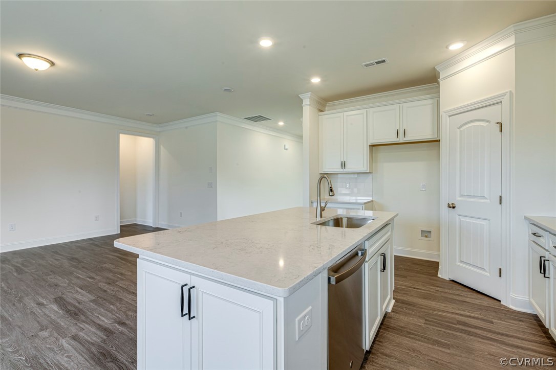 Photo represents the plan, not the actual home. Design selections may vary. The entry offers a formal dining room off of the foyer. The kitchen features an island and pantry open to cafe area. Bright and spacious family room open to kitchen. 
