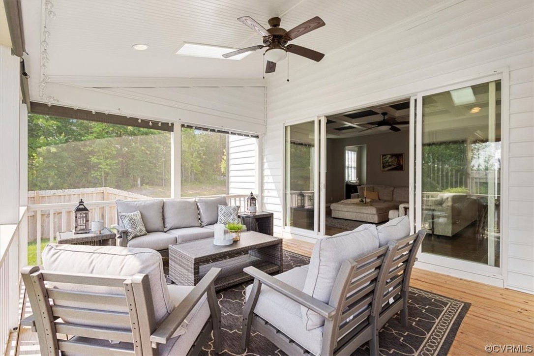 16X14 screened porch with vaulted ceiling, recessed and ceiling fan lights, view to the backyard and the sliding door entrance to the family room