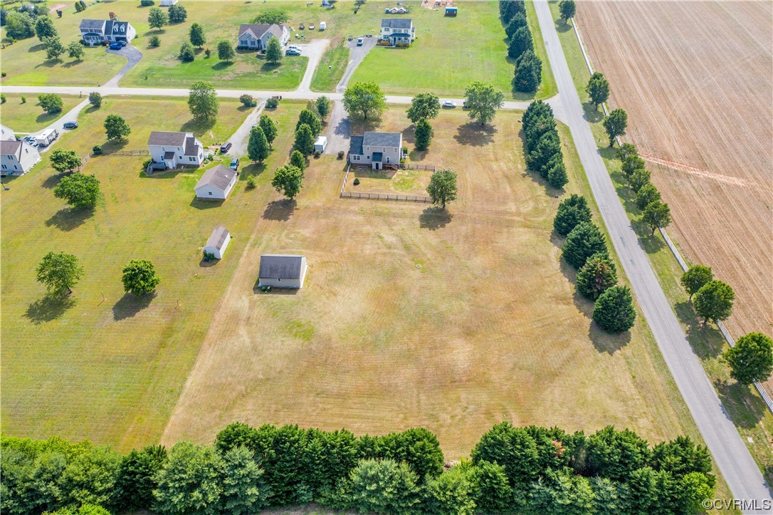 This aerial view shows the fenced in backyard and storage shed.