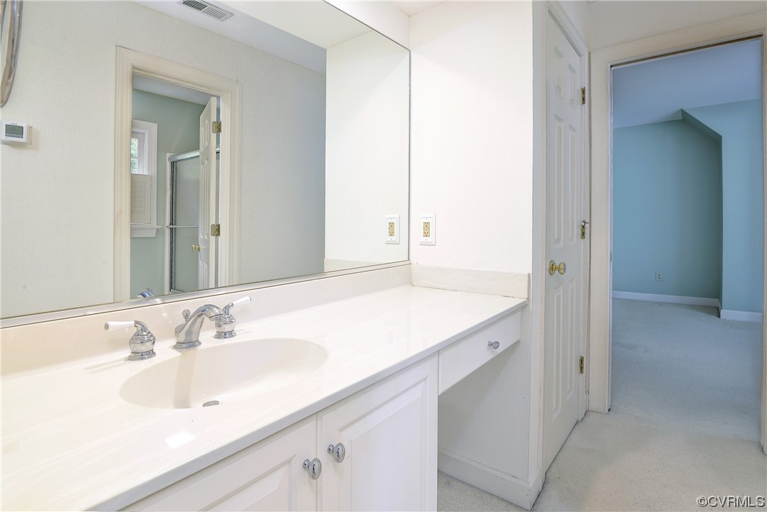 The Jack and Jill bath has a separate space for the vanity.
