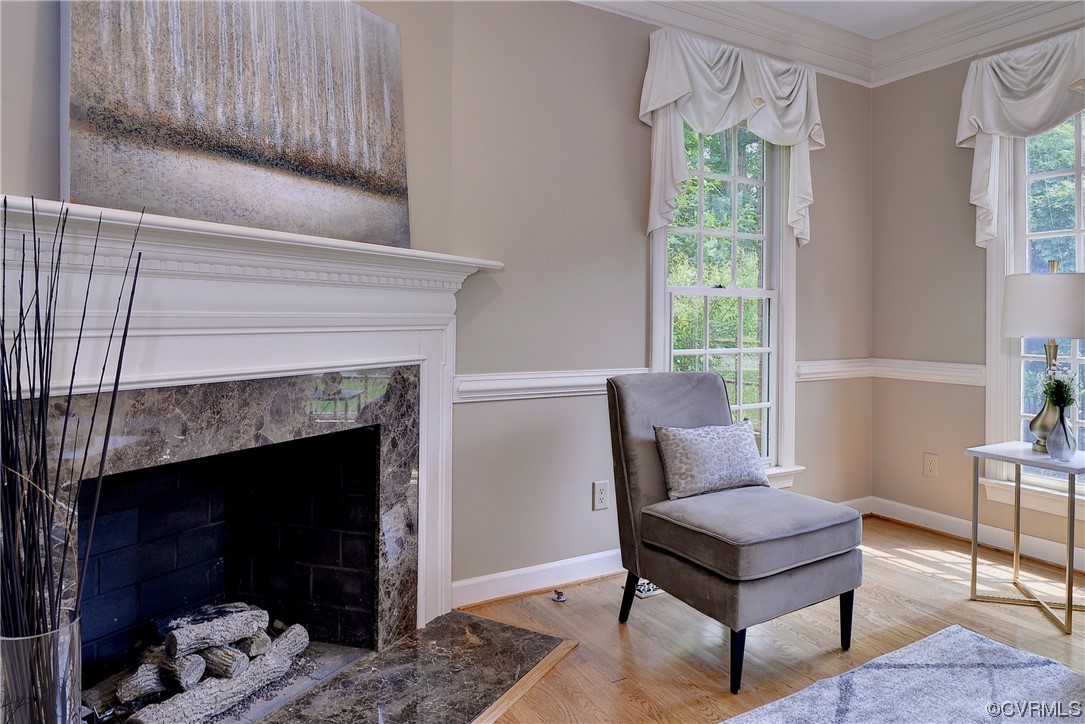 The living room is located to the right of the foyer and features hardwood floors and a gas fireplace.