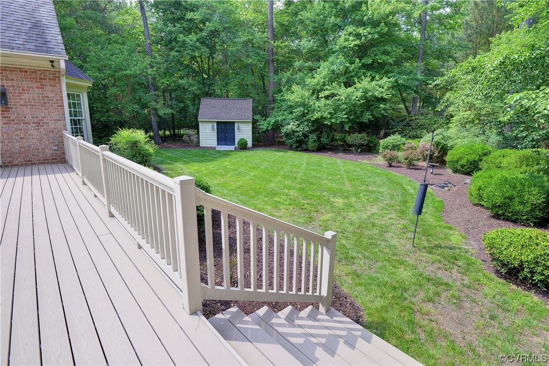 Step down from the deck to the beautiful private backyard.