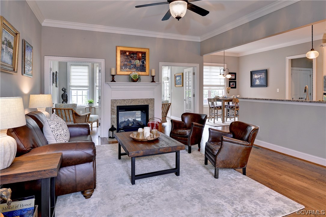 The great room opens to the kitchen and dining room and shares a double-sided gas fireplace with the sun room.