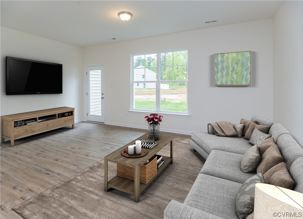 Photo represents the plan, not the actual home. Design selections may vary. The spacious family room is open to the kitchen and offers access to the rear patio.