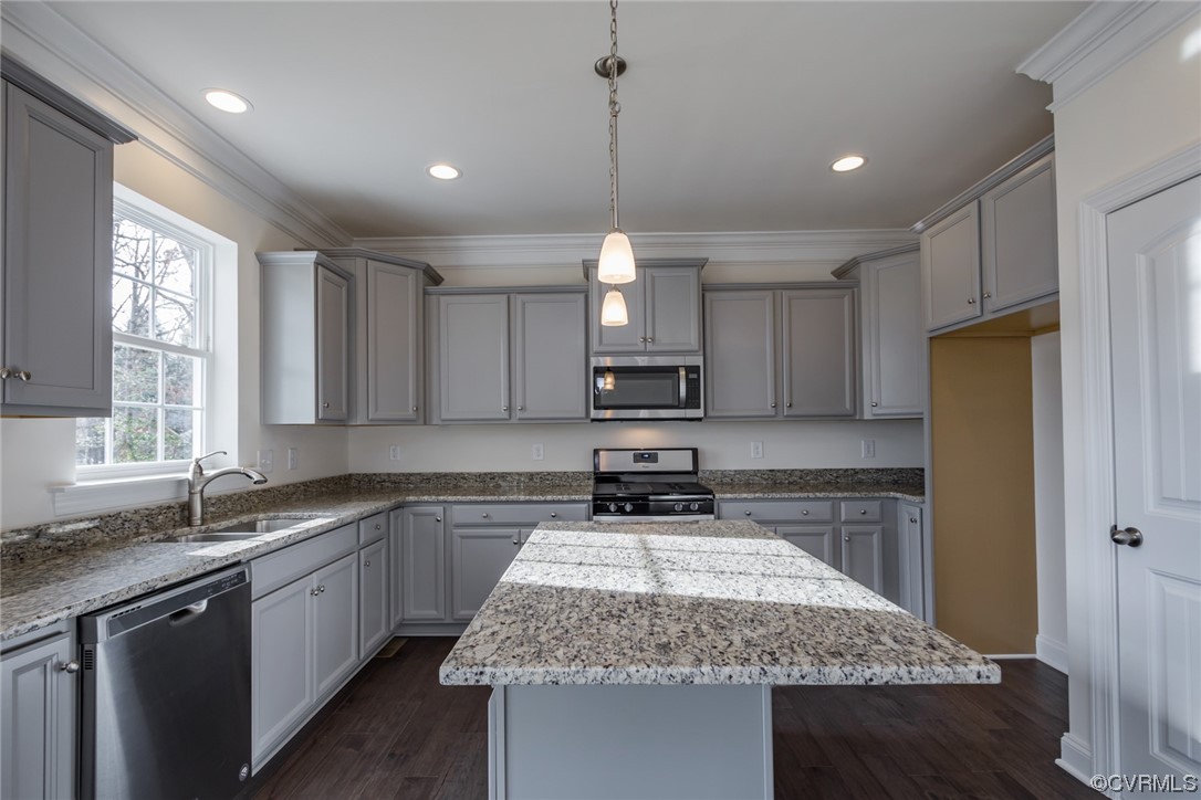 Photo represents the plan, not the actual home. Design selections may vary. The UPGRADED kitchen showcases stunning two-tone cabinets, sparkling white quartz counters, gas cooking, an island, pantry, and stainless steel appliances with an LED recessed lighting package.