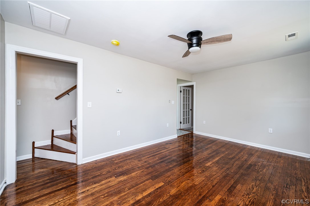 Empty room with hardwood floors and a ceiling fan