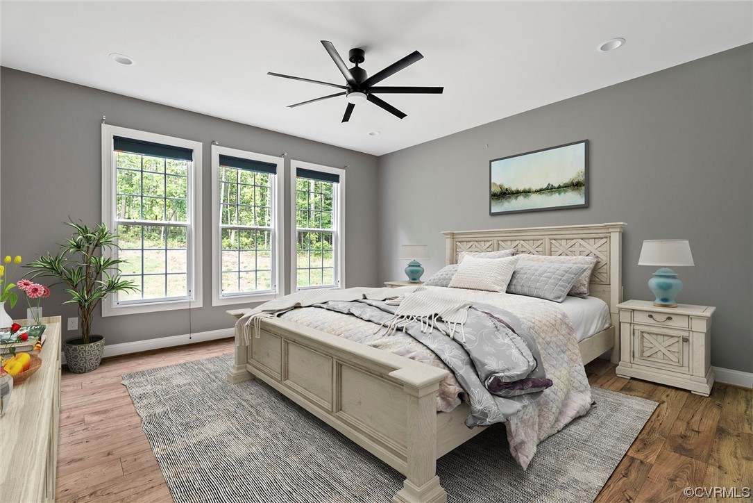 Bedroom with light hardwood flooring and ceiling fan