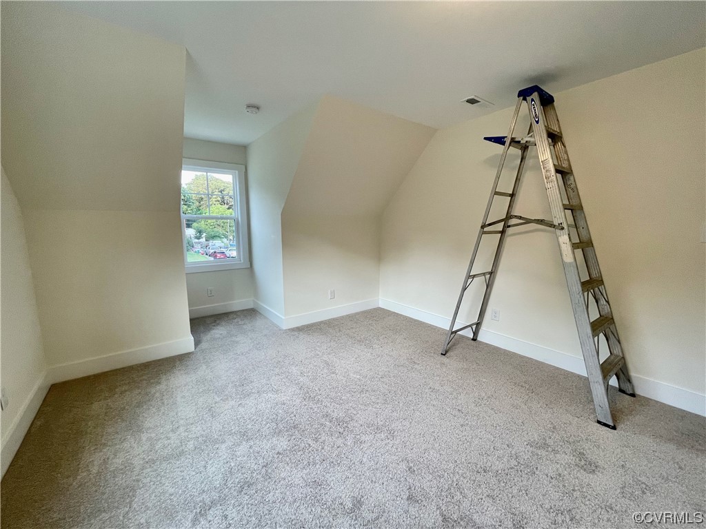 Upstairs bedroom  with carpet and natural light