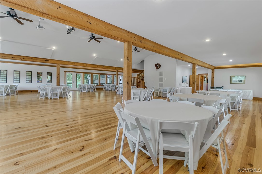 Dining area with hardwood floors, a ceiling fan, and wood beam ceiling