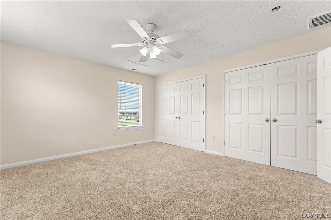 Second Bedroom with fresh paint, new carpet, ceiling fan, double closets & Jack & Jill Bath.