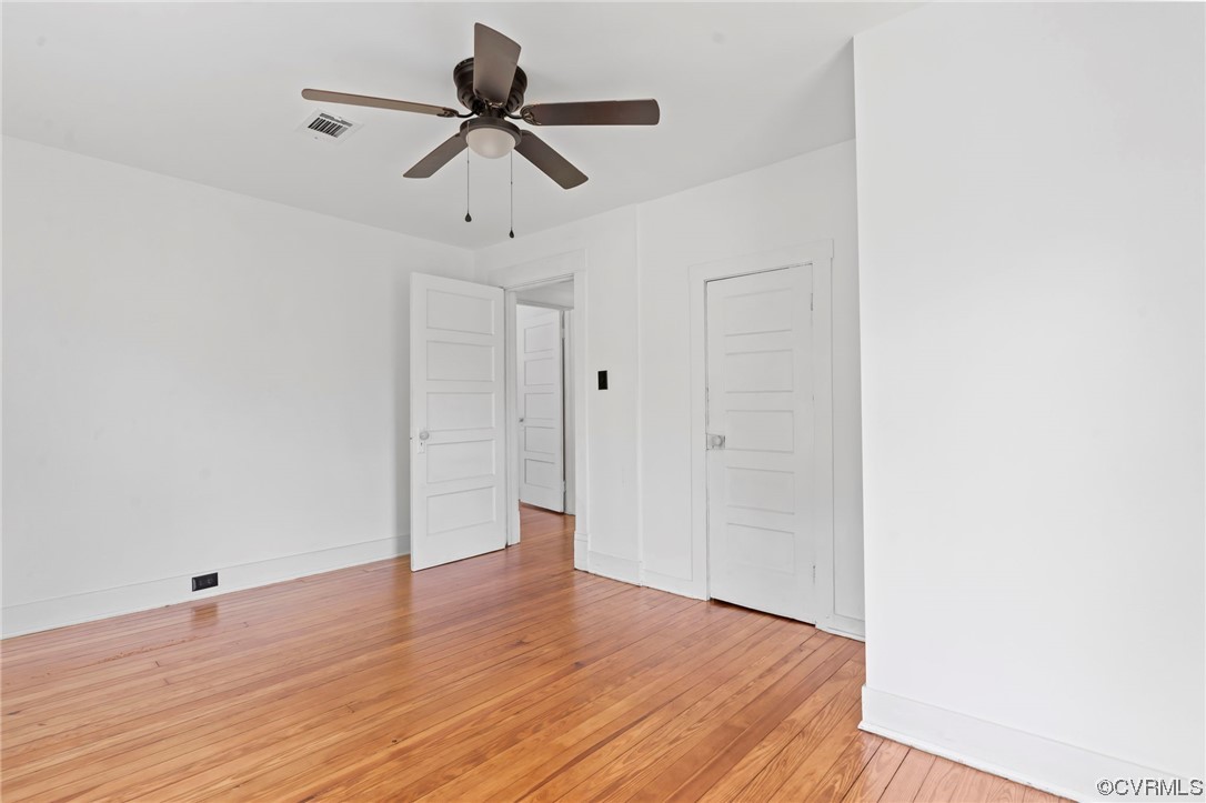 Unfurnished room with light hardwood floors and ceiling fan