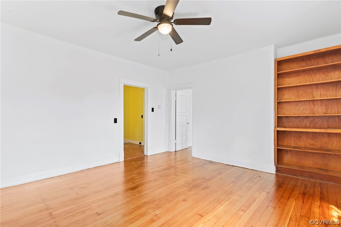Wood floored spare room with ceiling fan
