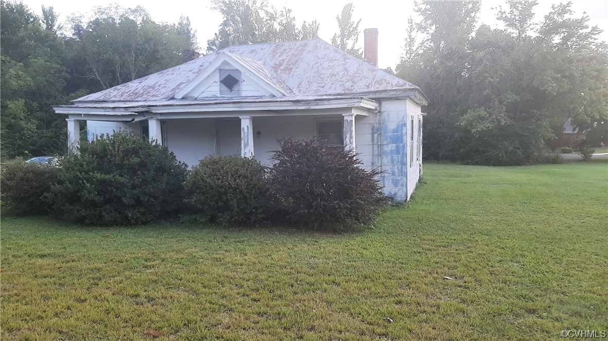 View of side of home with a lawn