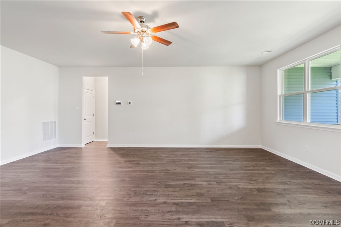Spare room with dark hardwood floors and ceiling fan