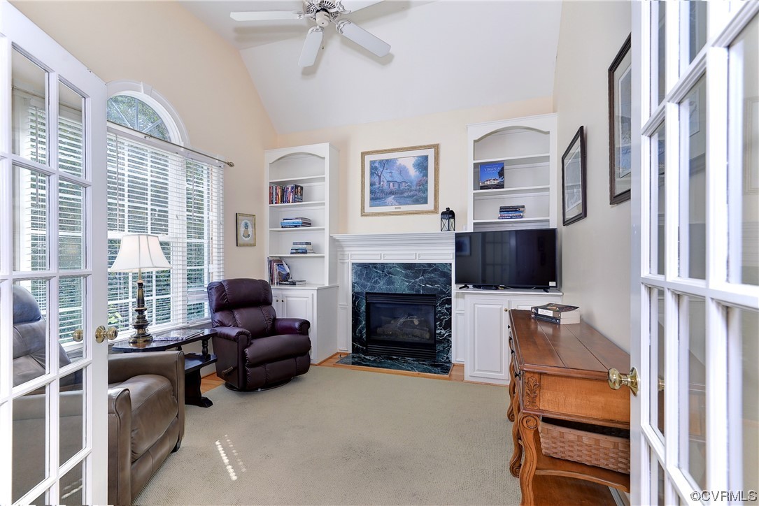 The den or living room features a second fireplace and a beautiful Palladian window.