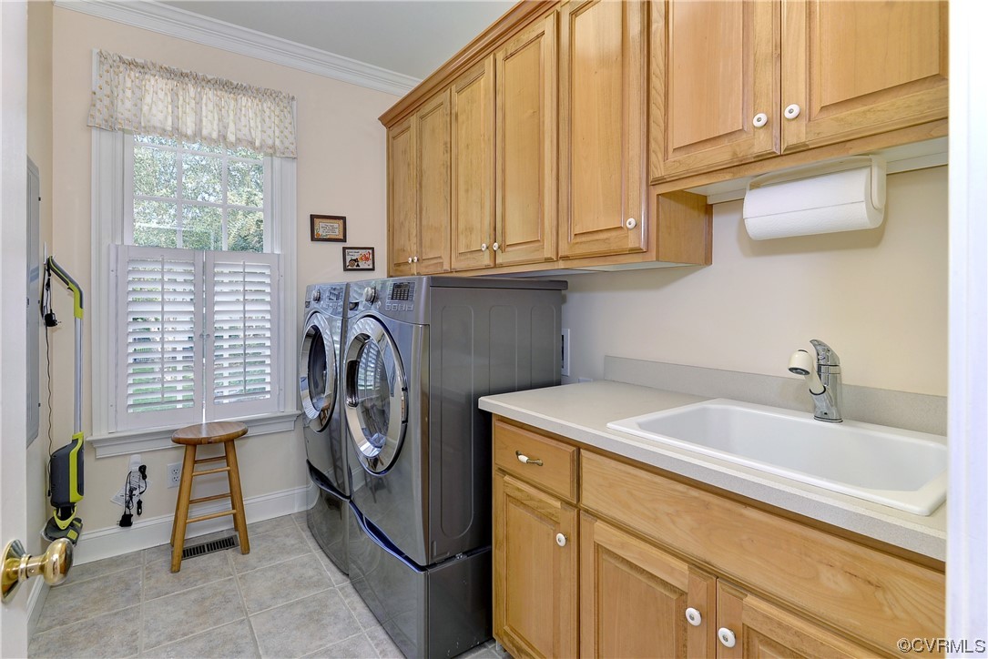 The first-floor laundry room has a utility sink and additional storage space.