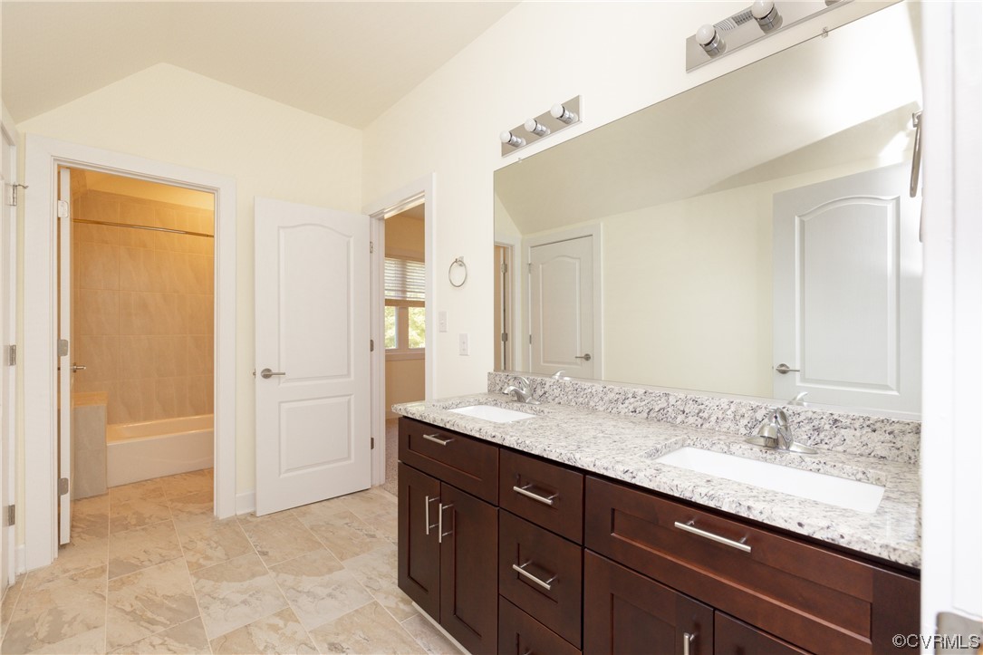Bathroom featuring double sink and tile floors