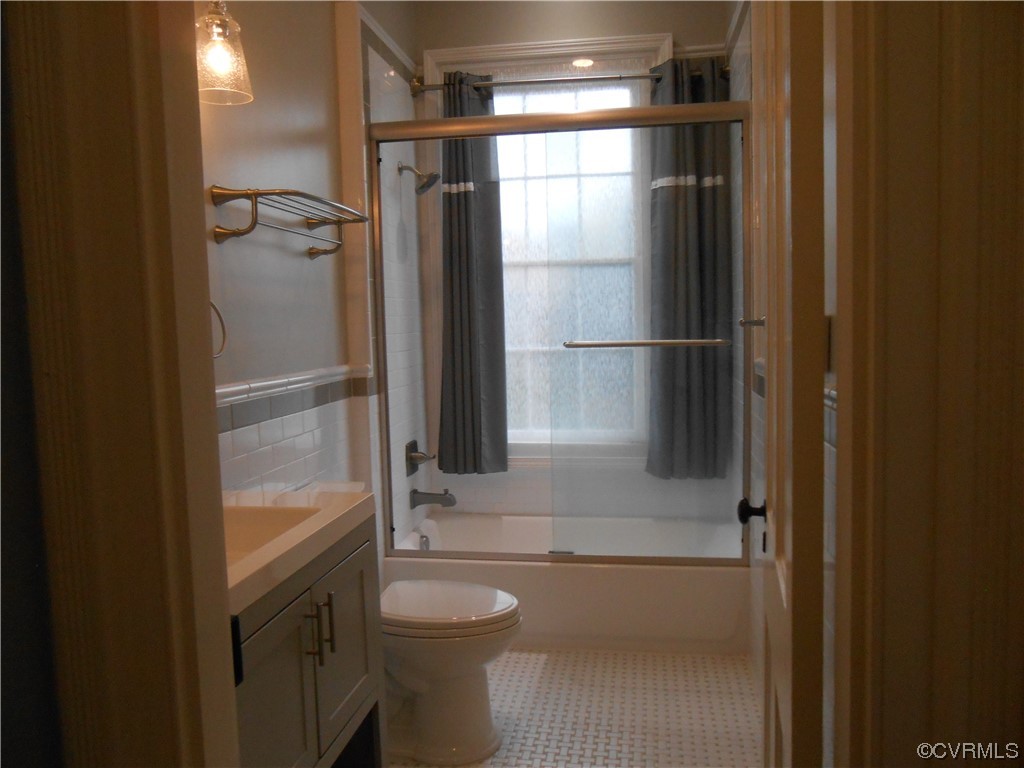 Full bathroom 2nd Floor. Beautiful Tile work. featuring a healthy amount of sunlight, and enclosed tub / shower combo