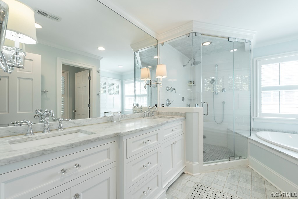 Bathroom featuring oversized vanity, tile flooring, ornamental molding, and plus walk in shower