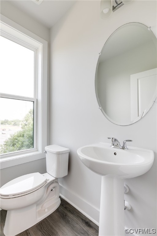 Bathroom featuring sink, hardwood flooring, and toilet