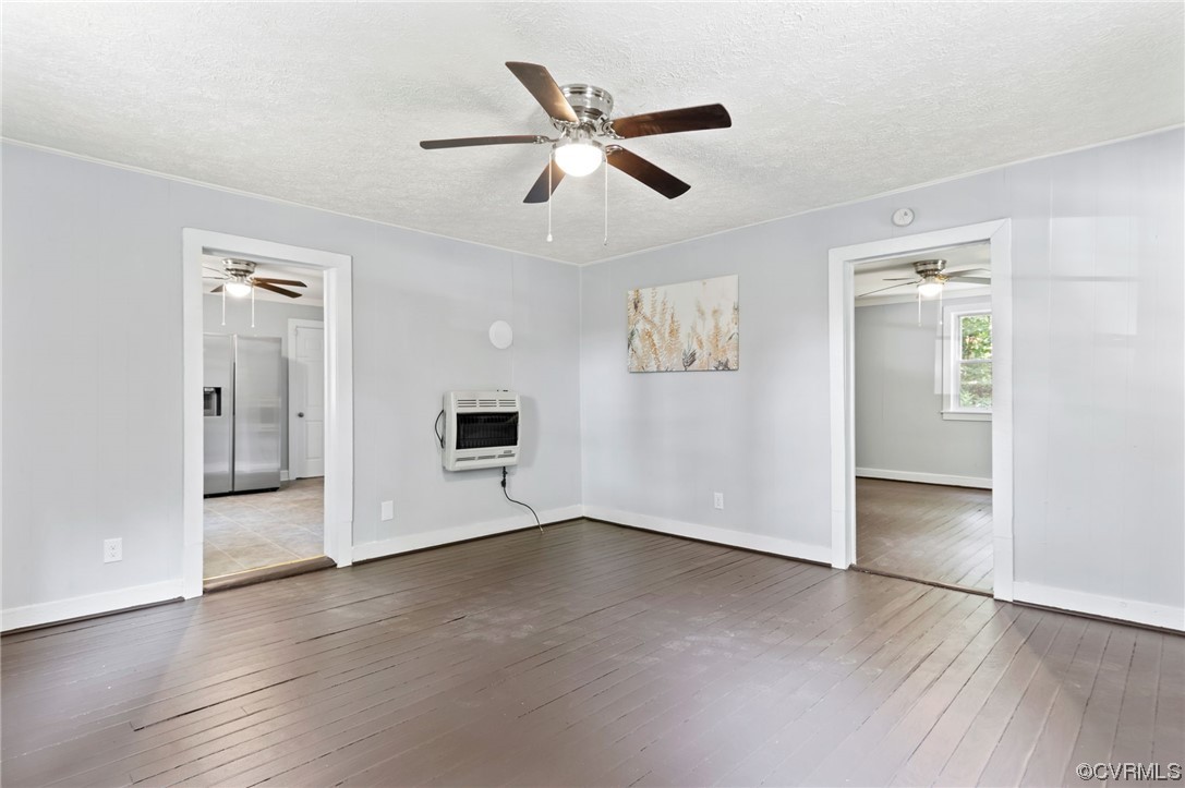 Interior space with hardwood / wood-style floors, ceiling fan, and a textured ceiling