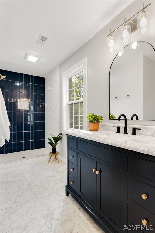 Bathroom with vanity and porcelain tile floors
