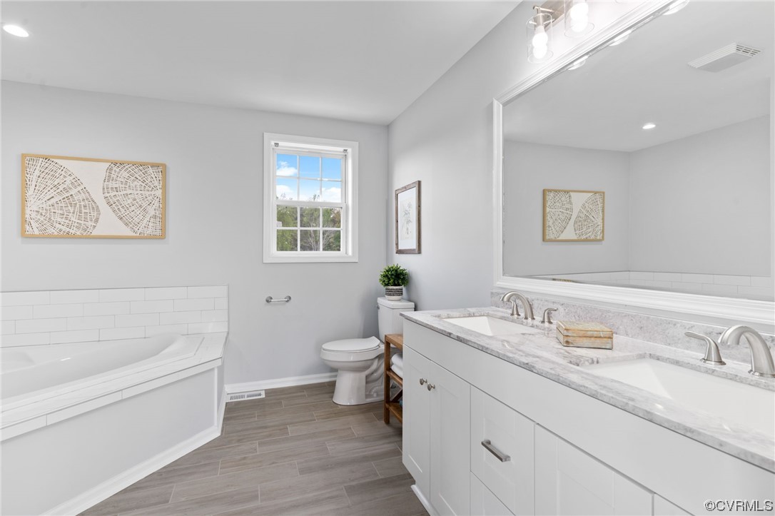En suite bath with double vanity and soaking tub