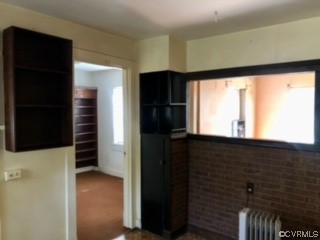 Kitchen with carpet and radiator