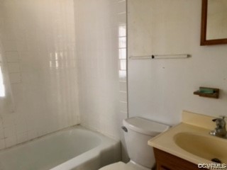 Full bathroom featuring shower / tub combination, vanity with extensive cabinet space, and toilet