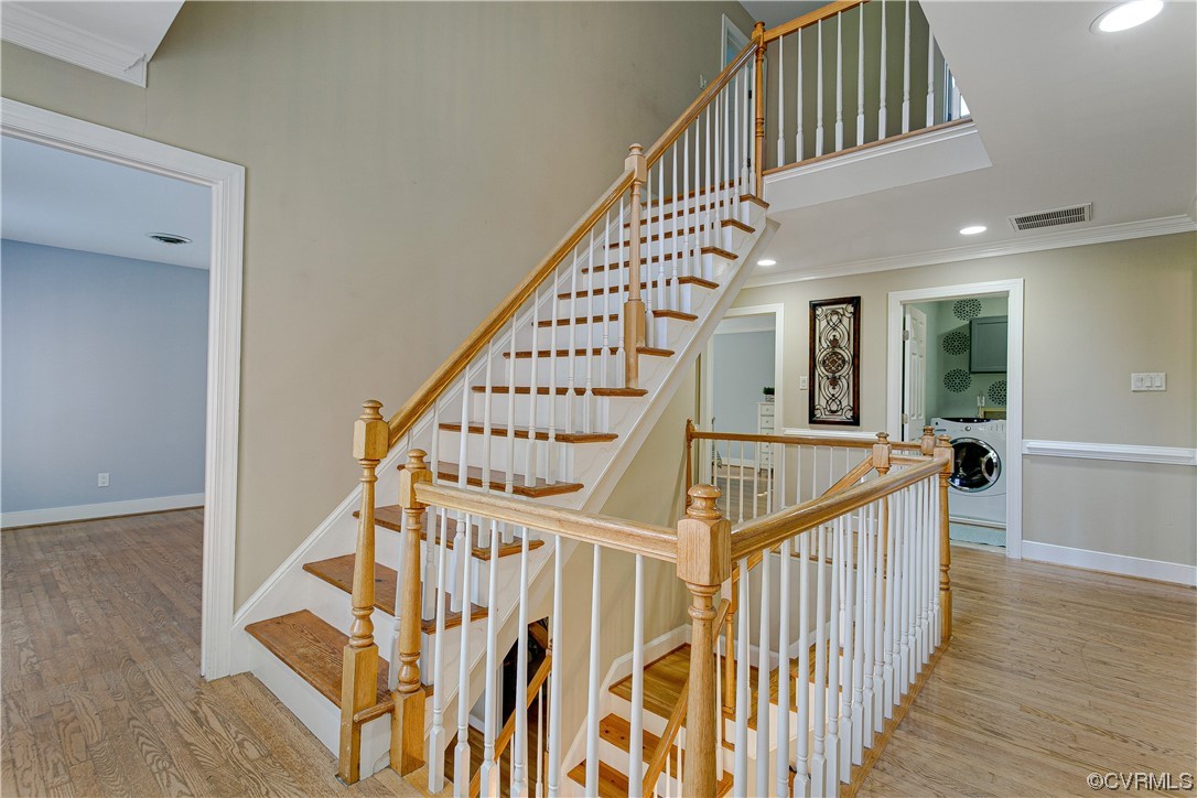 Stairs featuring light hardwood flooring