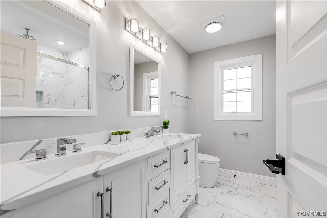 Primary full bathroom with double vanity, a sparkling quartz vanity top, and a shower have you saying 